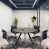 Apollo meeting table with a natural wood and black metal leg finish inside a corporate boardroom in Dubai.